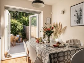A dining room with a table set for a meal at Coed y Felin in Conwy