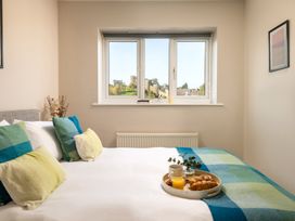 A bedroom with a bed and breakfast tray at Coed y Felin in Conwy