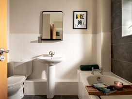 A bathroom with a sink, toilet, and bathtub at Coed y Felin in Conwy