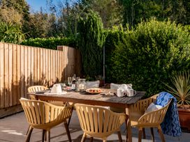 A dining area with a table and chairs at Coed y Felin, Conwy