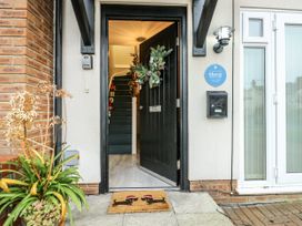 An entrance with a front door and staircase at Coed y Felin in Conwy