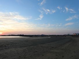 A beach with sand and water at Curragho in Trearddur Bay