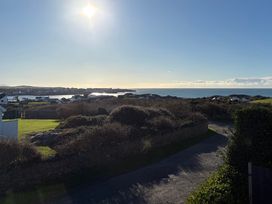 A scenic view of the ocean and houses at Curragho in Trearddur Bay
