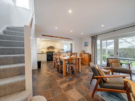 A dining room with a table and chairs at Curragho in Trearddur Bay