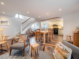 A dining room with a table and chairs at Curragho in Trearddur Bay