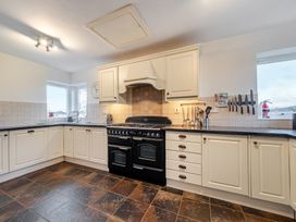 A kitchen with an oven and cabinets at Curragho in Trearddur Bay