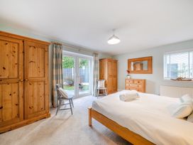 A bedroom with a bed and wardrobe at Curragho in Trearddur Bay