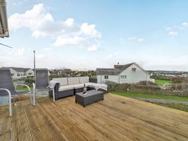 An outdoor seating area with a sofa and coffee table at Curragho in Trearddur Bay