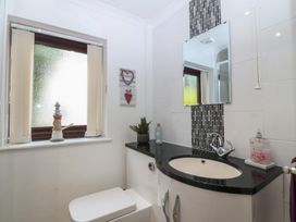 A bathroom with a sink and toilet at Gwylan Uchaf Y Felinheli