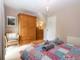 A bedroom with a bed and storage furniture at Machlud Ynys Y Felinheli