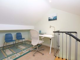 An office space with a desk and chairs at Machlud Ynys in Y Felinheli