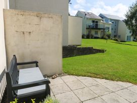 An outdoor area with a bench and grass at Machlud Ynys, Y Felinheli