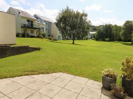 An outdoor area with buildings and a lawn at Machlud Ynys Y Felinheli