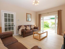 A living room with a sofa and coffee table at Menai Cottage in Brynsiencyn
