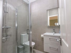 A bathroom with a shower and sink at Menai Cottage in Brynsiencyn