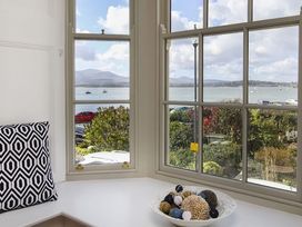 A living room with a window view at Tri Raglan Mawr in Beaumaris