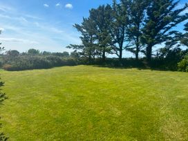 A garden with grass and trees at Ty Bryn - Nefyn in Morfa Nefyn