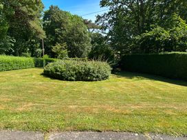A garden with grass and hedges at Ty Bryn - Nefyn Morfa Nefyn