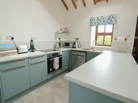 A kitchen with appliances and countertop at Tyn y Mynydd in Bull Bay