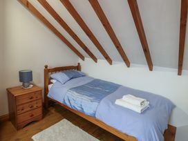 A bedroom with a single bed and nightstand at Tyn y Mynydd Bull Bay