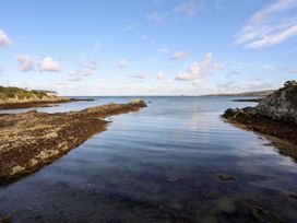 A coastal scene with water and rocks at Tyn y Mynydd in Bull Bay