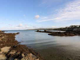 A view of the sea with rocks and seaweed at Tyn y Mynydd in Bull Bay