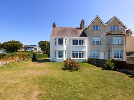A house with windows and grass area at Windygates in Rhosneigr