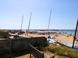 A beach with vehicles and people at Windygates in Rhosneigr