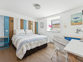 A bedroom with a bed and desk at Ysbryd y Mynydd in South Stack