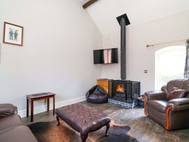 A living room with a sofa and coffee table at Clwyd Cottage St Asaph