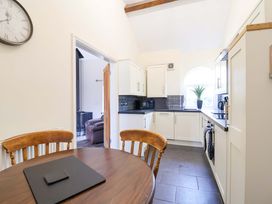 A kitchen with a table and chairs at Clwyd Cottage in St Asaph