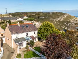 A house with a garden and pathway at Ty Bach, Great Orme Llandudno