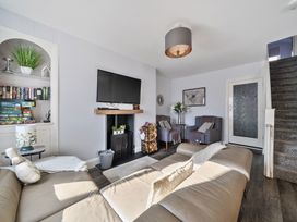 A living room with a sofa and TV at Ty Mawr, Great Orme in Llandudno