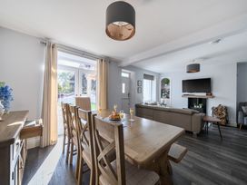 A dining room with a table and chairs at Ty Mawr, Great Orme, Llandudno