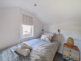 A bedroom with a bed and side table at Ty Mawr, Great Orme Llandudno