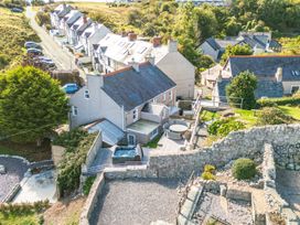 An outdoor view of houses and garden with a jacuzzi at Ty Mawr, Great Orme Llandudno
