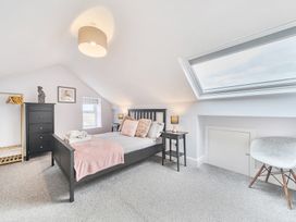 A bedroom with a bed and black furniture at Ty Mawr, Great Orme in Llandudno