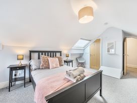 A bedroom with a bed and bedside tables at Ty Mawr, Great Orme in Llandudno