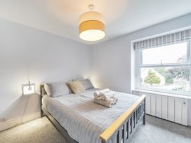 A bedroom with a bed and towels at Ty Mawr, Great Orme in Llandudno