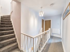 A hallway with stairs and a handrail at Ty Mawr, Great Orme in Llandudno