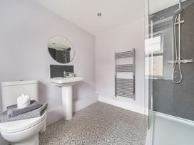 A bathroom with a sink, toilet, and shower at Ty Mawr, Great Orme in Llandudno