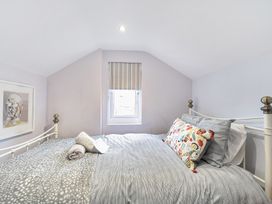 A bedroom with a bed and window at Ty Mawr, Great Orme in Llandudno