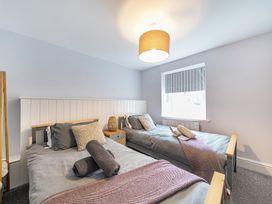 A bedroom with two beds and a window at Ty Mawr, Great Orme in Llandudno