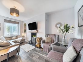 A living room with a sofa and television at Ty Mawr, Great Orme in Llandudno