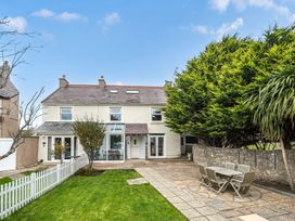 A garden with a house and outdoor seating at Ty Mawr, Great Orme in Llandudno
