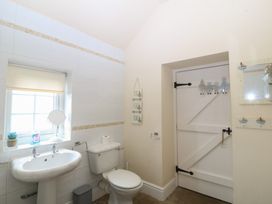 A bathroom with a sink and toilet at Llanallgo Church Rooms