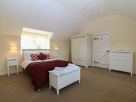 A bedroom with a bed and furniture at Llanallgo Church Rooms 