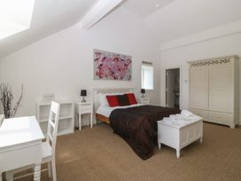 A bedroom with a bed and furniture at Llanallgo Church Rooms