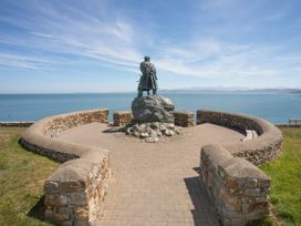 A statue overlooking the sea at a coastal viewpoint