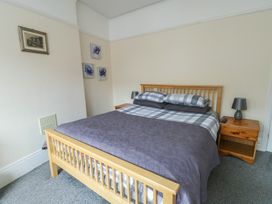 A bedroom with a double bed and bedside table at Sea Breeze in Rhos-on-Sea